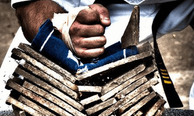 A person holding onto some wood