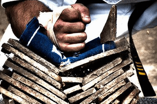 A person holding onto some wood