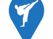 A blue and white map pin with a person kicking