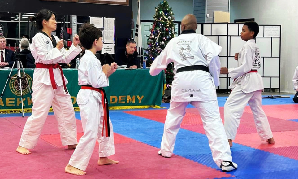 Instructors teaching practical self-defense techniques and tactical safety awareness in a martial arts class.