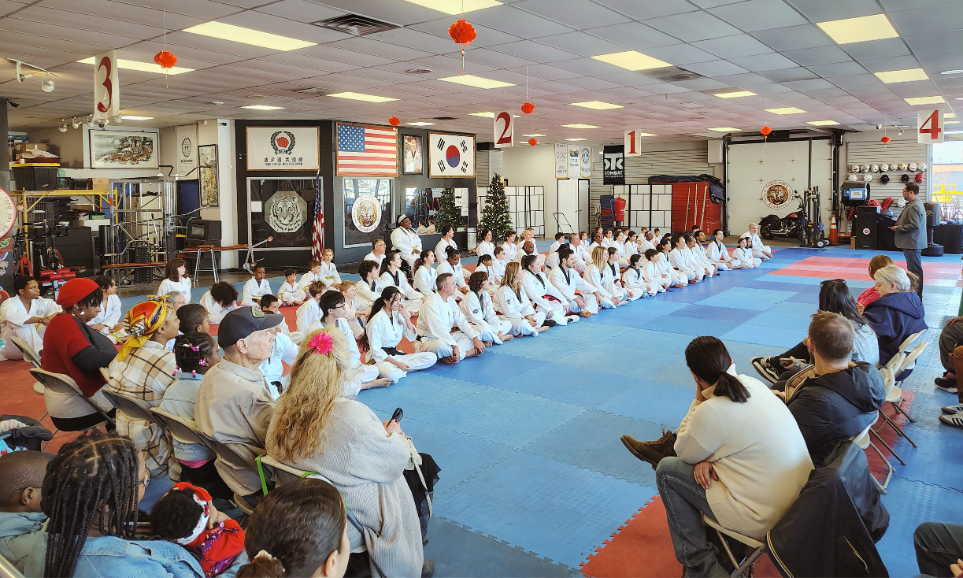 Martial arts students training together during a high-energy Taekwondo class.